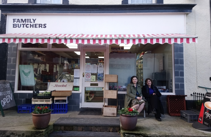 Janet in front of a butchers.